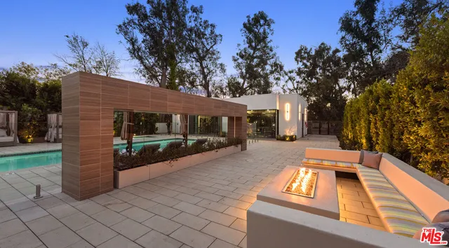 a view of a patio with dining table and chairs with wooden floor and fence