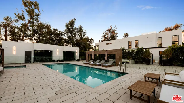 a view of a patio with swimming pool table and chairs