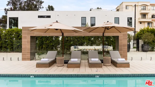 a view of a house with pool and a yard
