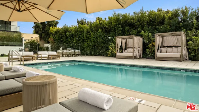 a view of a patio with swimming pool table and chairs