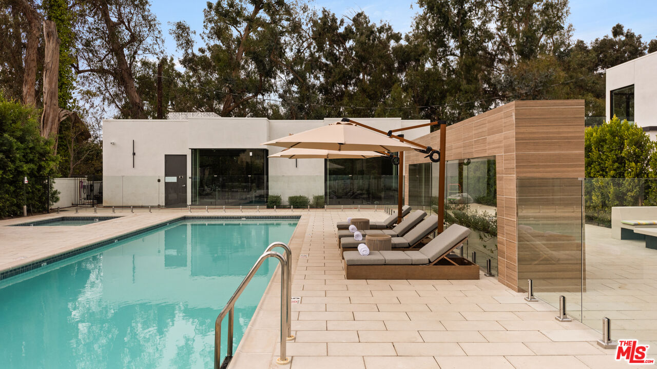 505 South Barrington Avenue, Unit 303 Los Angeles, CA 90049 - Photo 32 of 41 a view of a patio with swimming pool table and chairs