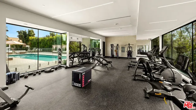 a room with gym equipment and a large window