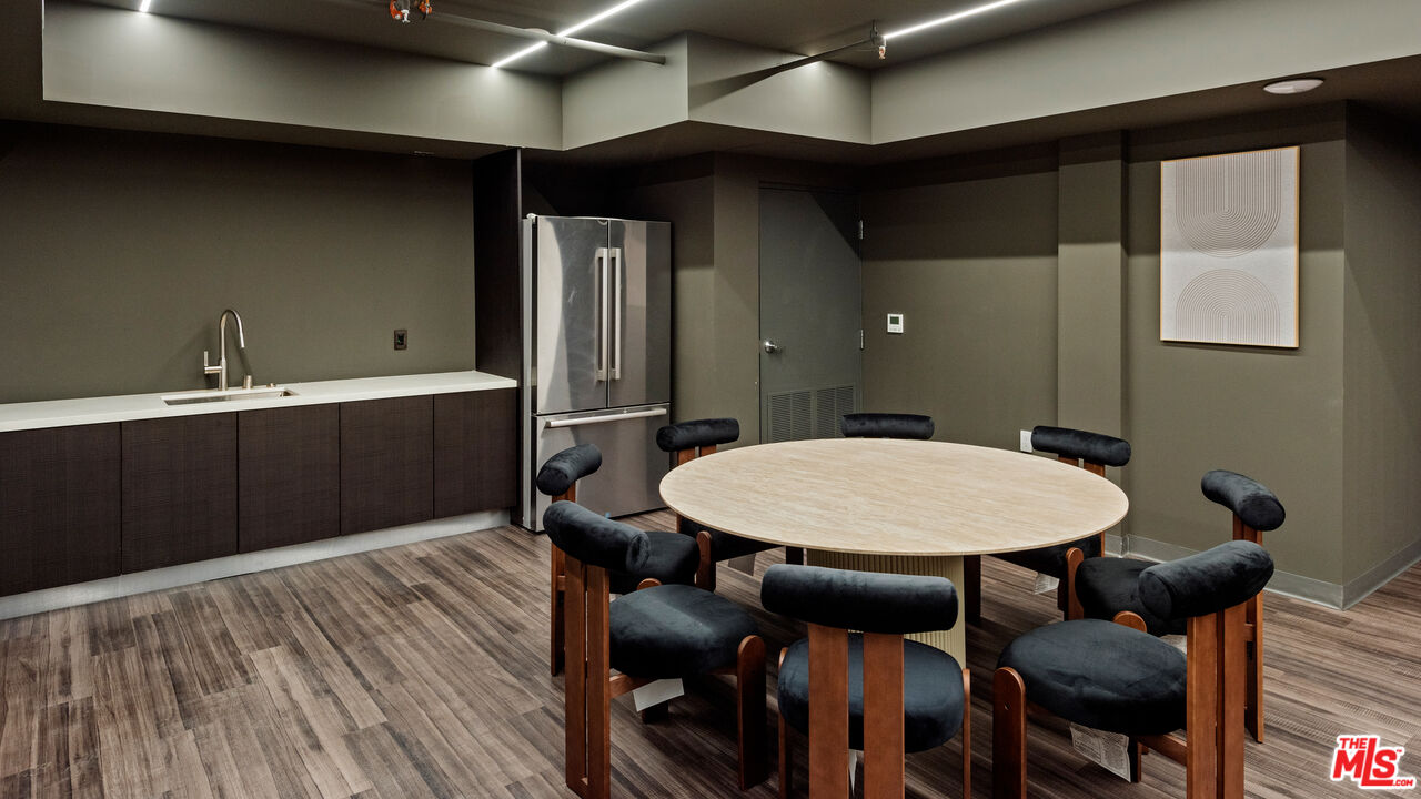 505 South Barrington Avenue, Unit 303 Los Angeles, CA 90049 - Photo 40 of 41 a view of a room that has a table and chairs in it