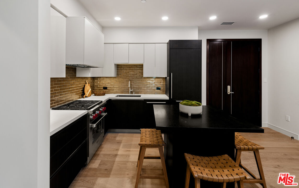 505 South Barrington Avenue, Unit 303 Los Angeles, CA 90049 - Photo 4 of 41 a kitchen with a sink and cabinets