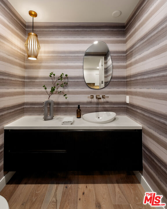 505 South Barrington Avenue, Unit 303 Los Angeles, CA 90049 - Photo 6 of 41 a bathroom with a sink and a mirror