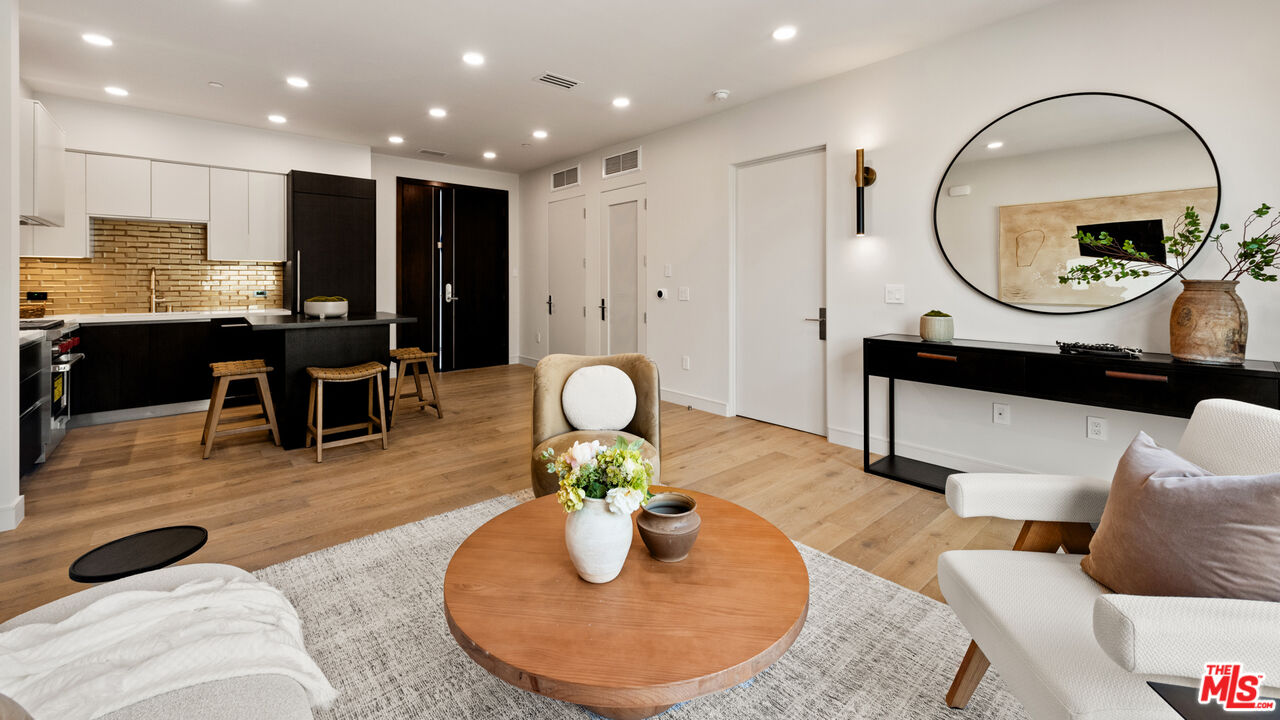 505 South Barrington Avenue, Unit 303 Los Angeles, CA 90049 - Photo 8 of 41 a living room with furniture and a wooden floor