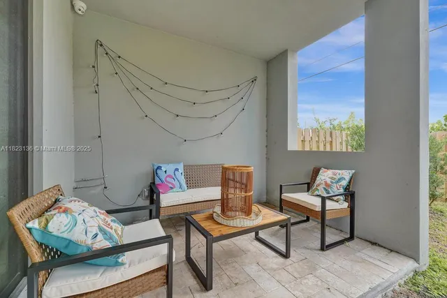 a living room with furniture and a rug