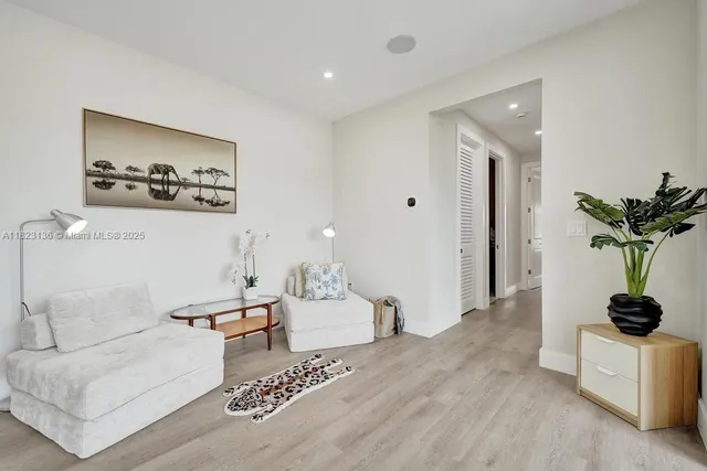 a living room with furniture and a potted plant