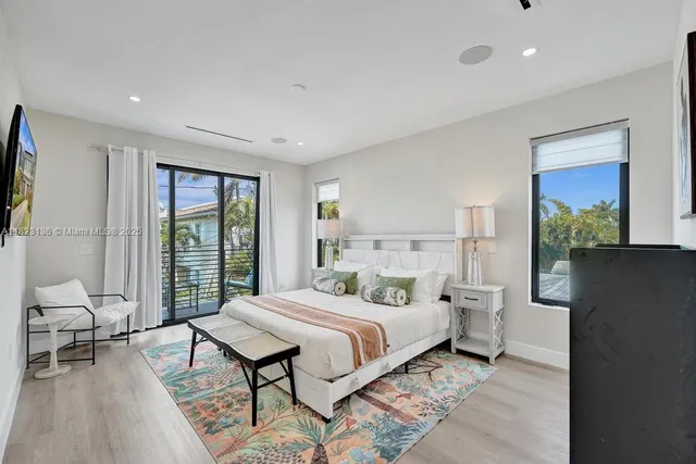 a bedroom with a large bed and a window