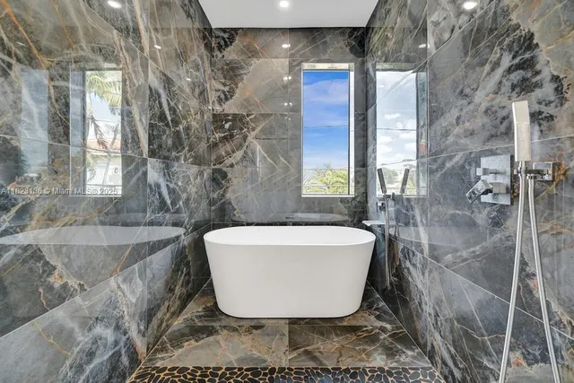 a bathroom with a bathtub and shower