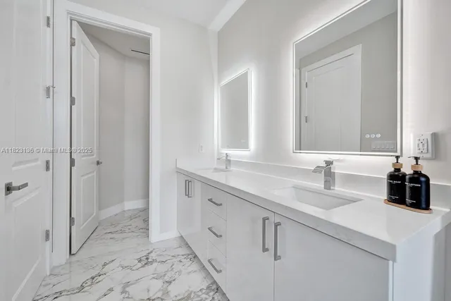 a bathroom with a double vanity sink and a mirror