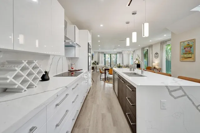 a large kitchen with stainless steel appliances kitchen island granite countertop a lot of counter space and a sink
