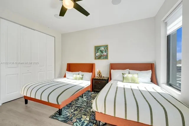 a bedroom with a bed and glass walk in closet