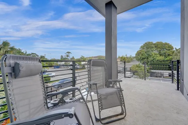 a view of a balcony with chairs