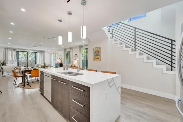 a kitchen with a sink and cabinets