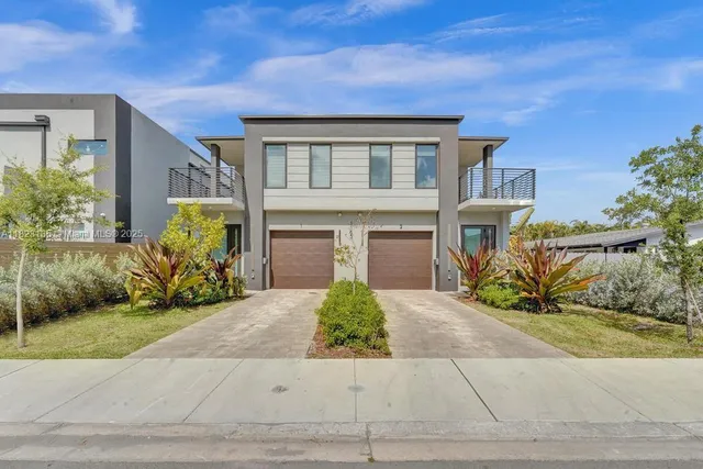 a aerial view of a house with a yard and balcony