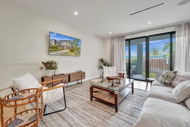 a living room with furniture and a large window