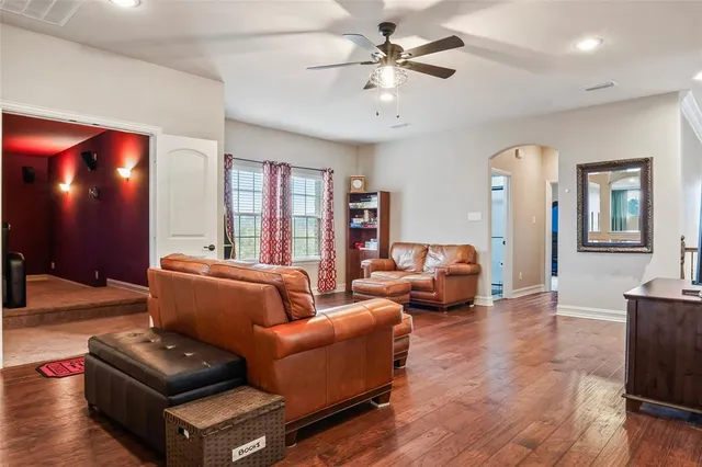 a living room with furniture and wooden floor
