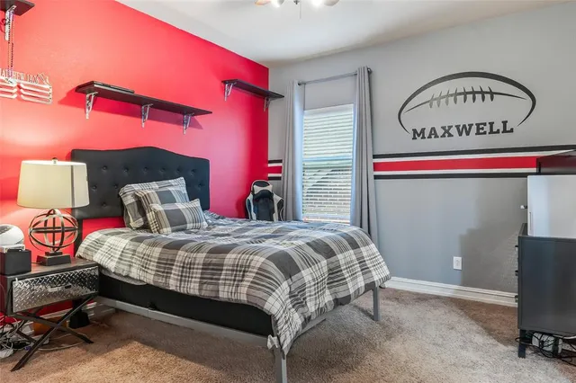 a bedroom with bed and a mirror