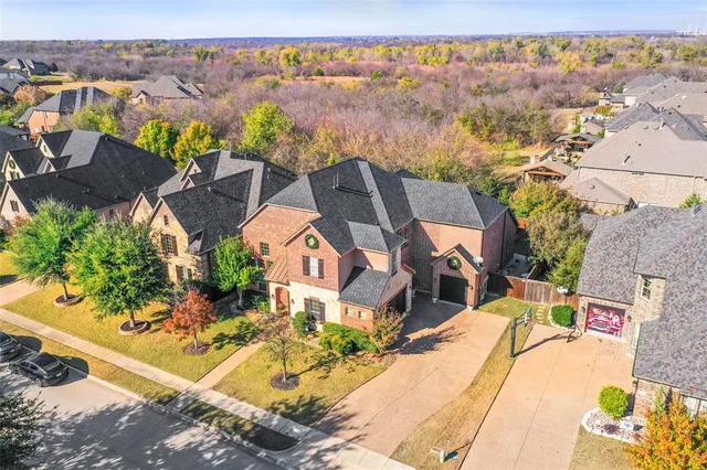 an aerial view of a house with a yard pool and outdoor seating