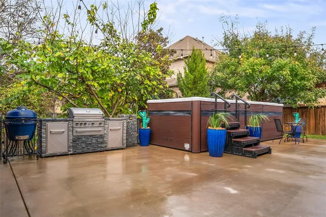 a view of a chairs and table in the backyard