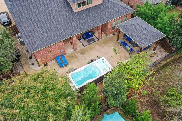 an aerial view of a house with a yard