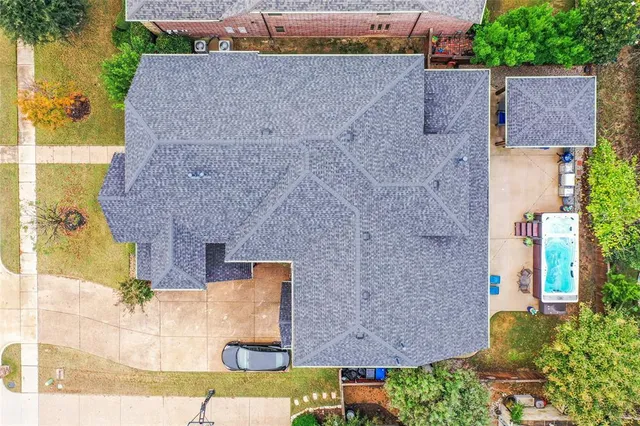 an aerial view of a house with a yard