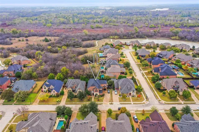 an aerial view of residential houses with outdoor space and parking