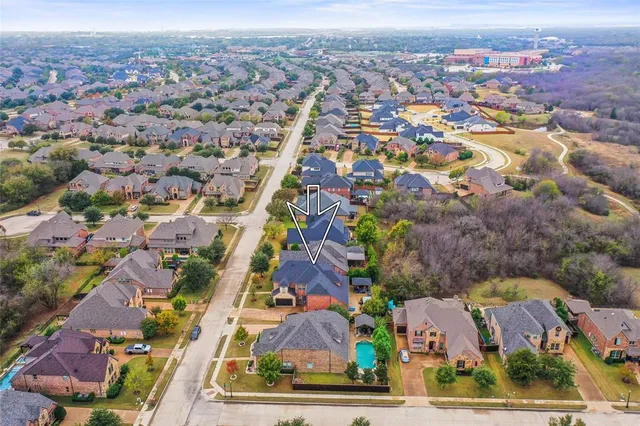 an aerial view of residential houses with outdoor space