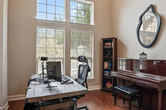 a view of a workspace with furniture and a window
