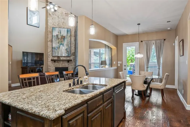 a kitchen with granite countertop a sink a counter top space and living room