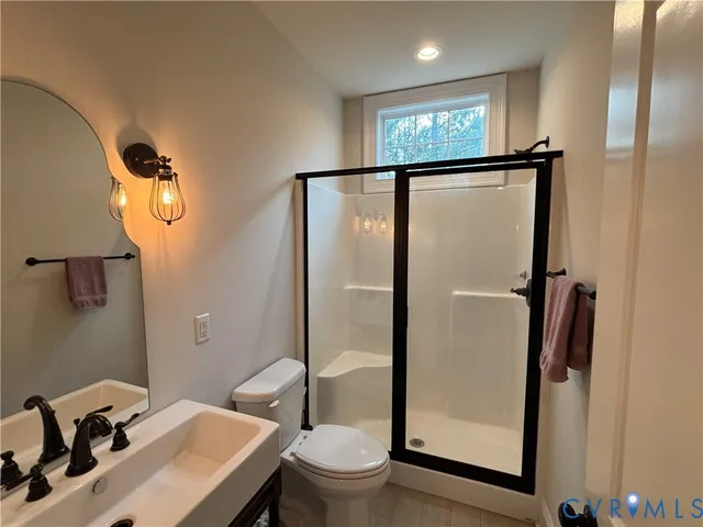 a bedroom with a bed and a television