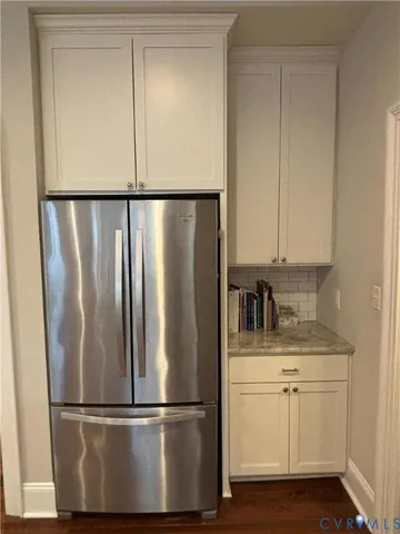 a metallic refrigerator freezer sitting in a kitchen