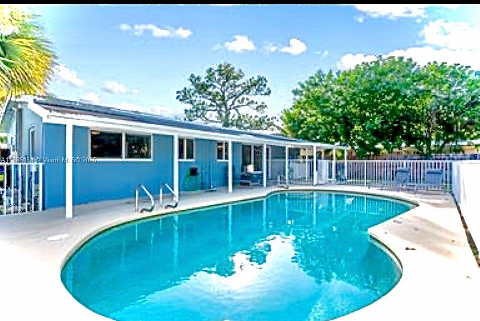 a view of a swimming pool with a patio
