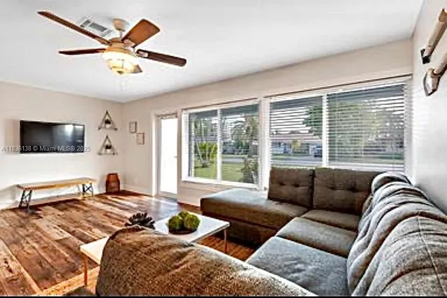 a bedroom with furniture and large windows