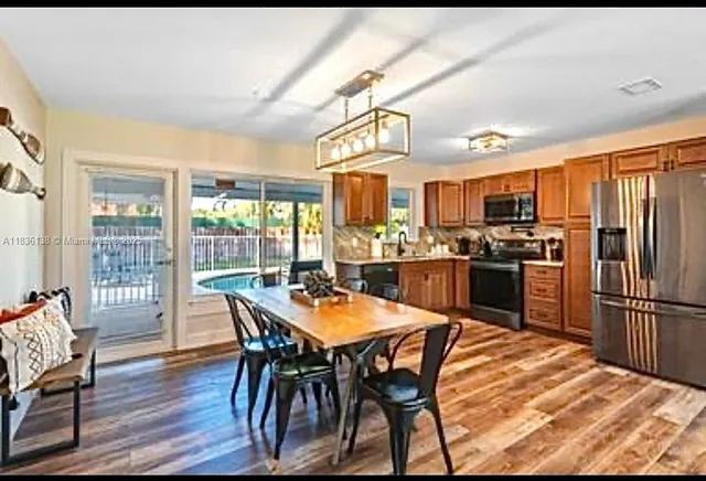 a view of a dining room with furniture large window and wooden floor