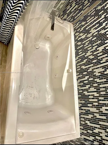 a bathroom with a bathtub and shower