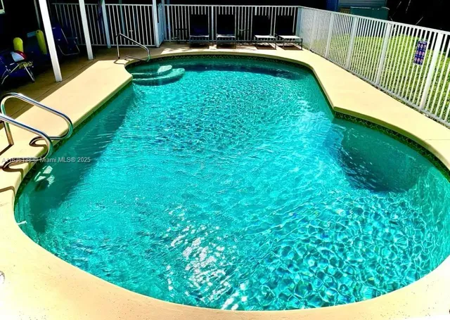 a view of a swimming pool with a lounge chairs