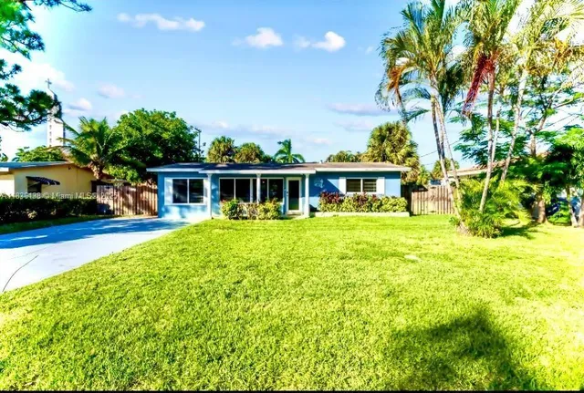 a view of a house with pool and sitting area