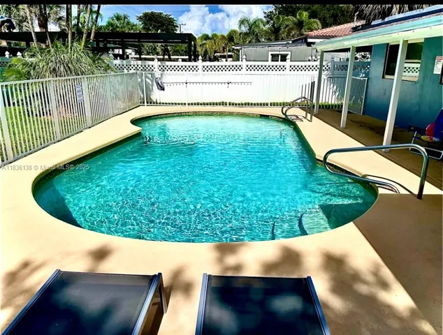 a view of a swimming pool with a patio