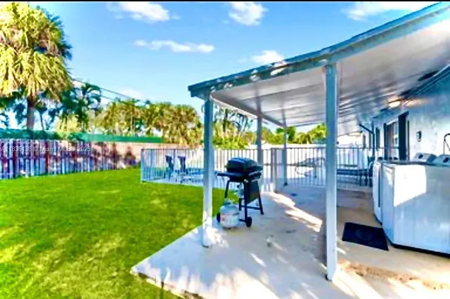 a view of a patio with a table and chairs