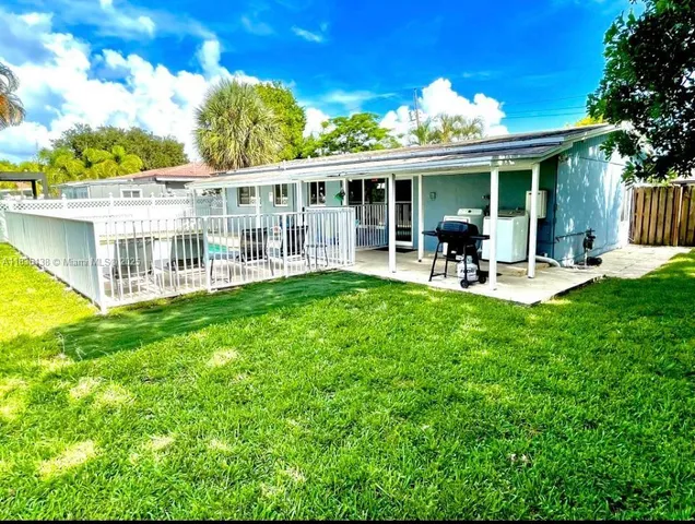 a view of a house with a yard and porch