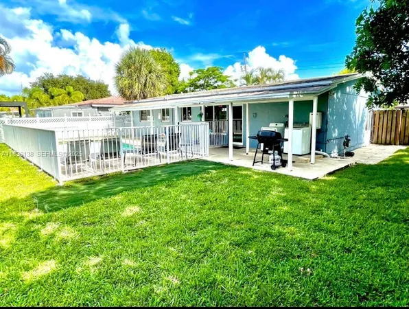a view of a house with a yard and porch
