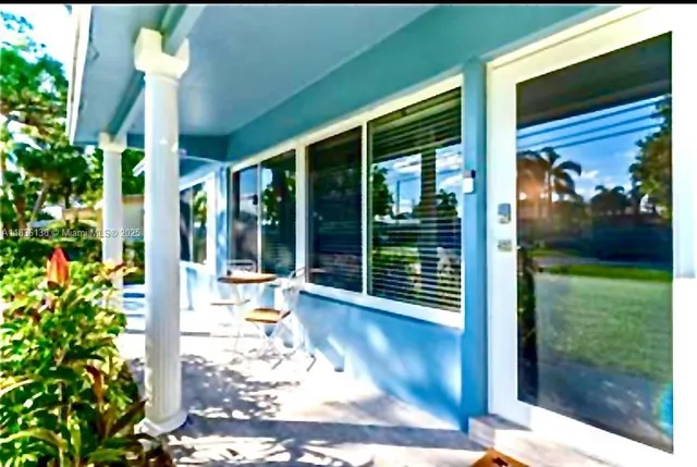 a view of a porch with chairs and backyard