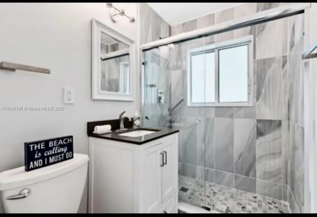 a bathroom with a sink a toilet and a shower