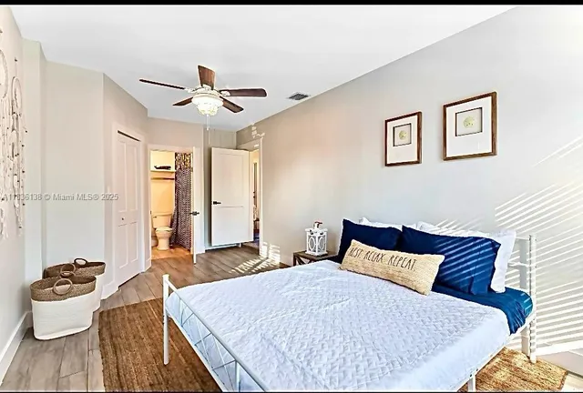 a bedroom with a bed and ceiling fan