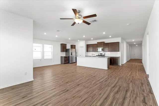 a view of kitchen with cabinets and wooden floor