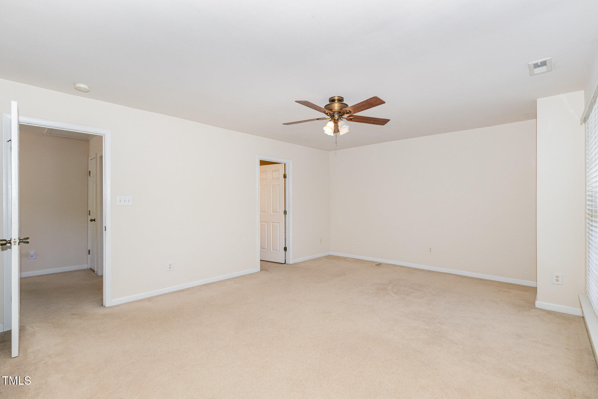 2126 Kedvale Avenue Raleigh, NC 27617 - Photo 13 of 18 an empty room with a ceiling fan and a window