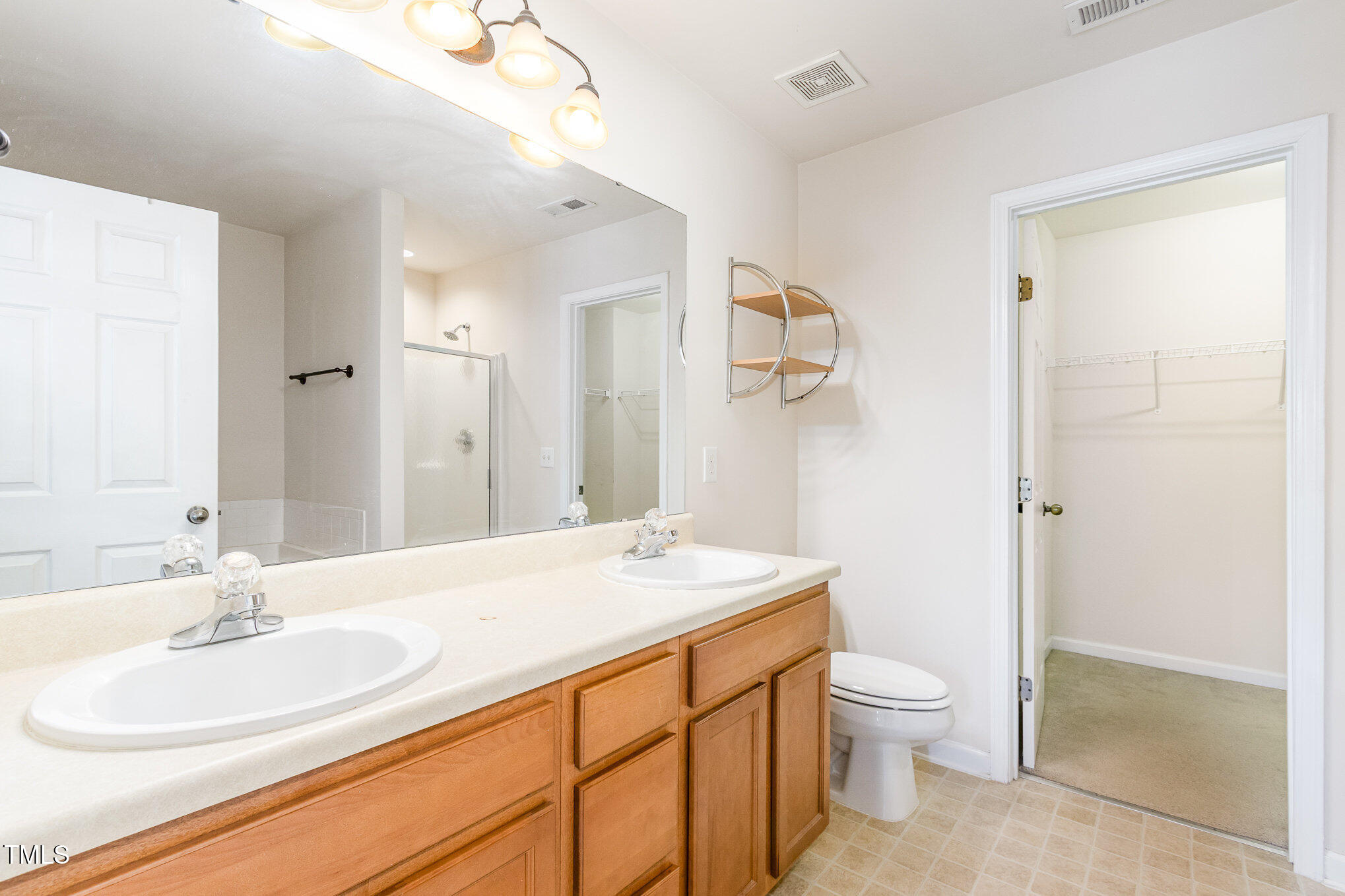2126 Kedvale Avenue Raleigh, NC 27617 - Photo 14 of 18 a bathroom with a granite countertop sink mirror vanity and toilet