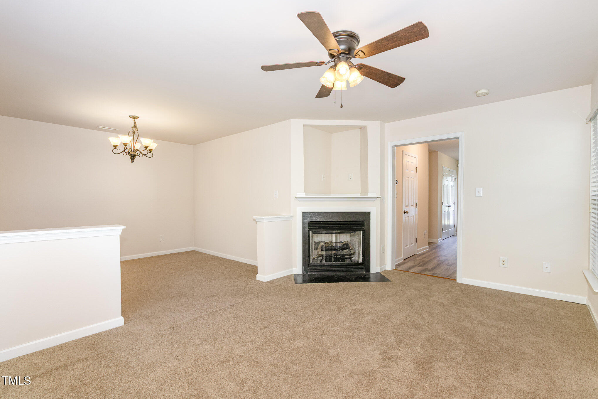 2126 Kedvale Avenue Raleigh, NC 27617 - Photo 6 of 18 an empty room with windows and fireplace